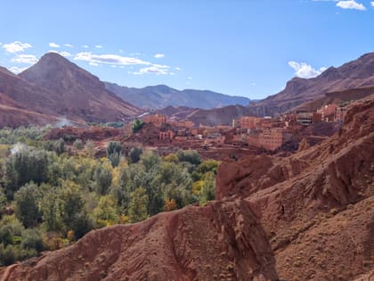 Red rock and green fields in the Dades Valley, a village pressed against the slope
